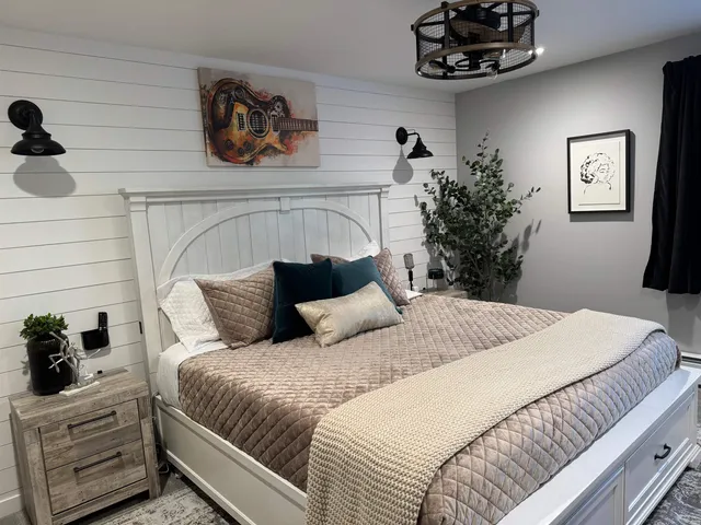 a bedroom with a bed and a chandelier