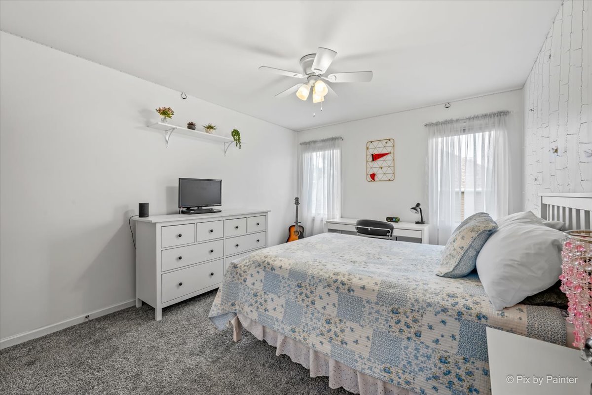 7104 Dove Way Cary, IL 60013 - Photo 34 of 82 a bedroom with a bed and a chandelier