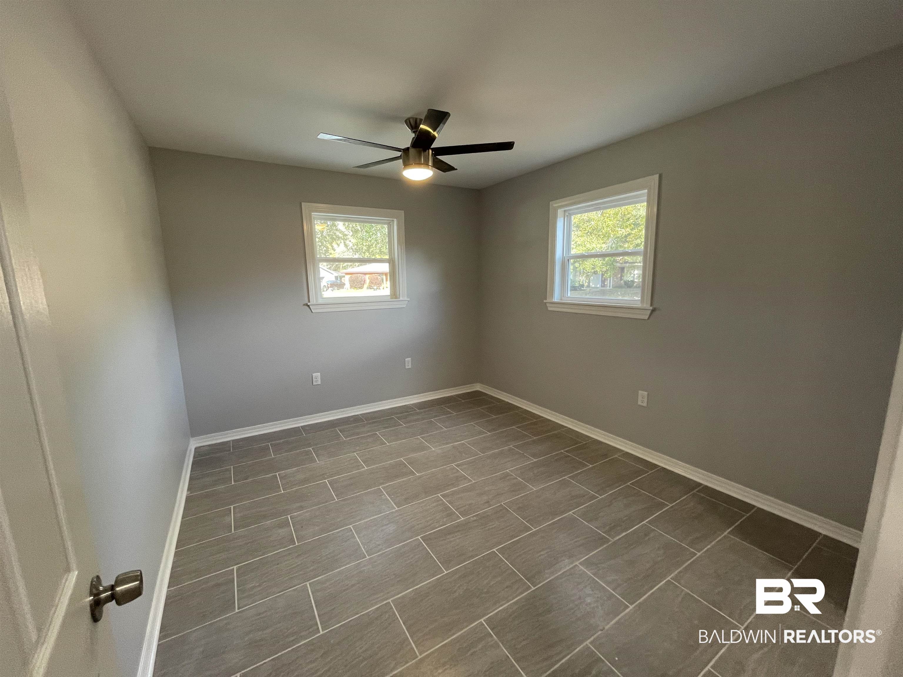 3901 Prima Vera Lane Mobile, AL 36605 - Photo 9 of 15 Spare room featuring a healthy amount of sunlight and ceiling fan