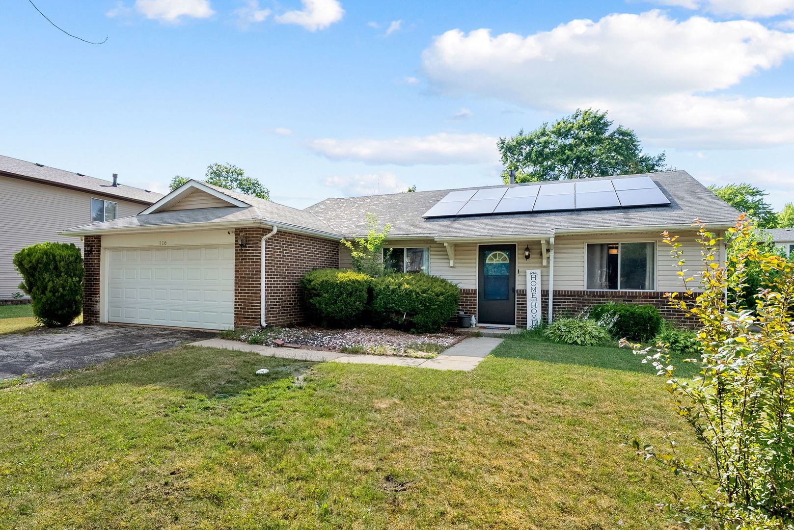 116 Cloverleaf Road Matteson, IL 60443 - Photo 3 of 8 a front view of a house with a garden and yard