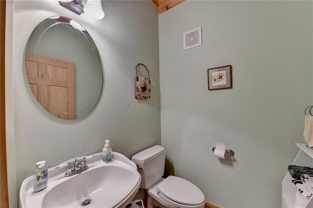 82 Walnut Grove Lane Tiger, GA 30576 - Photo 38 of 88 a bathroom with a toilet a sink and mirror
