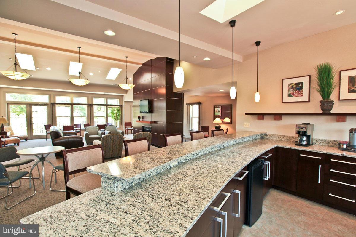 1785 Jonathan Way, Unit B Reston, VA 20190 - Photo 15 of 26 a kitchen with stainless steel appliances granite countertop sink stove and living room view
