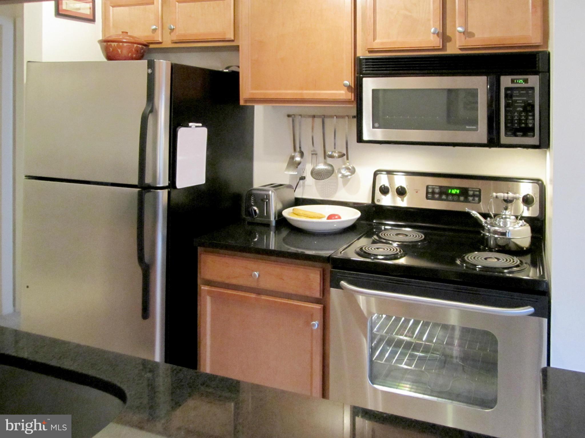 1785 Jonathan Way, Unit B Reston, VA 20190 - Photo 5 of 26 a kitchen with a sink and a refrigerator