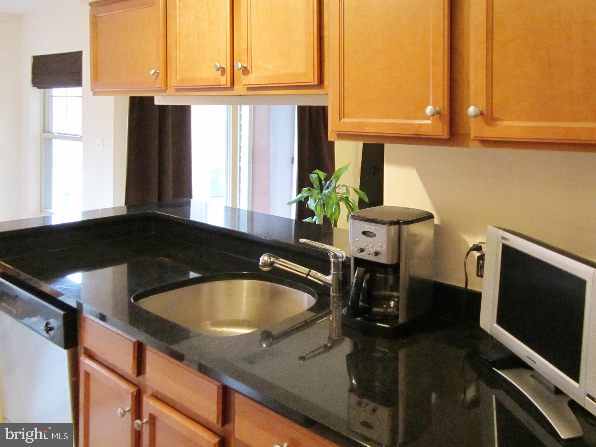 1785 Jonathan Way, Unit B Reston, VA 20190 - Photo 6 of 26 a kitchen with a sink a counter top space and cabinets
