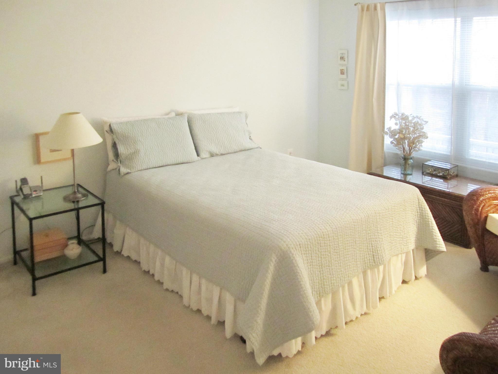 1785 Jonathan Way, Unit B Reston, VA 20190 - Photo 7 of 26 a bedroom with a bed and a night stand
