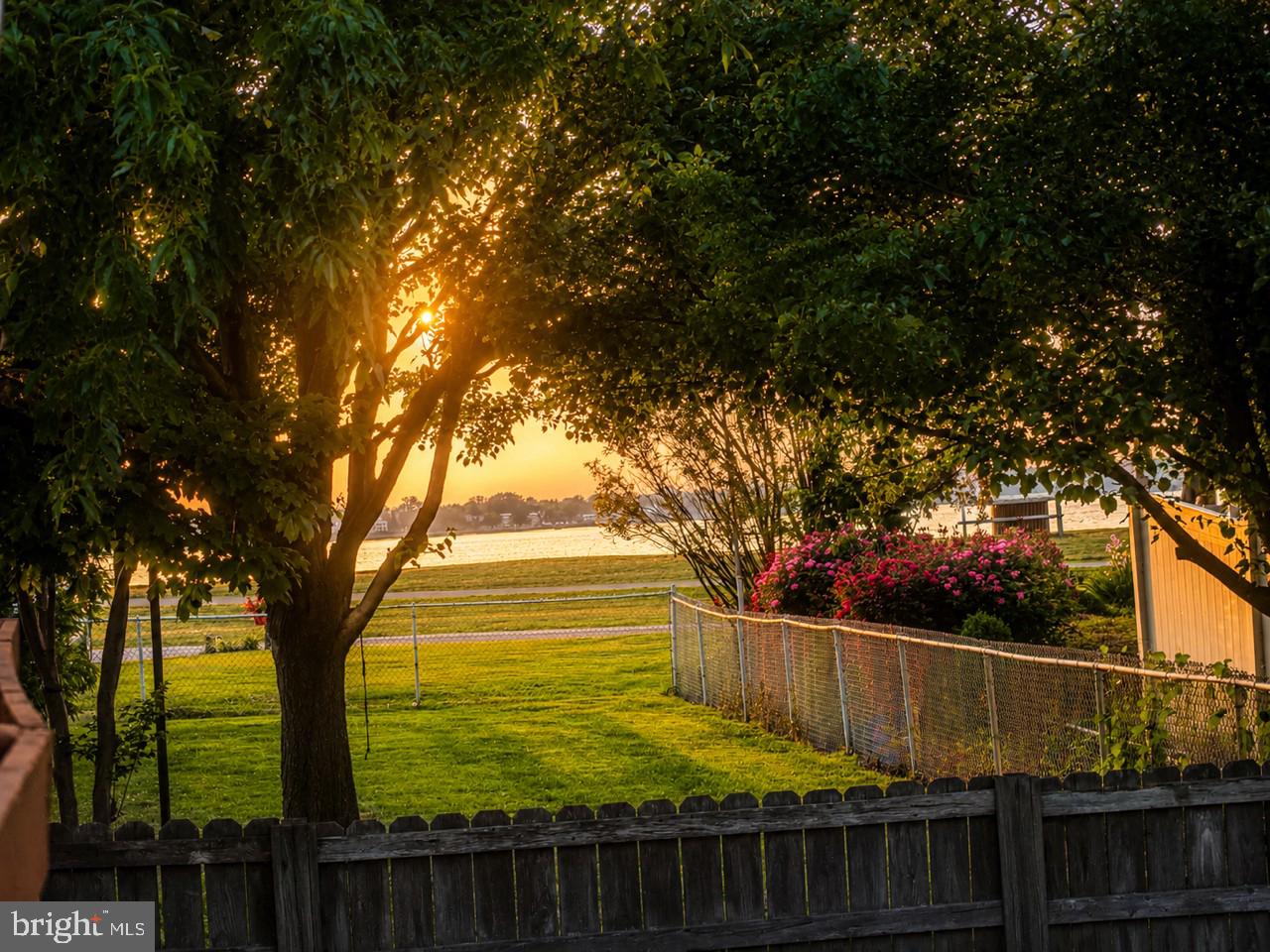 174 Kansas Road Pennsville, NJ 08070 - Photo 6 of 22 a view of a yard with wooden fence