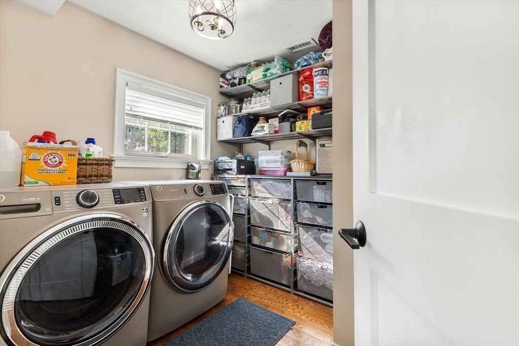 23 Locust Street, Unit 2 Danvers, MA 01923 - Photo 15 of 32 a storage room with washer and dryer
