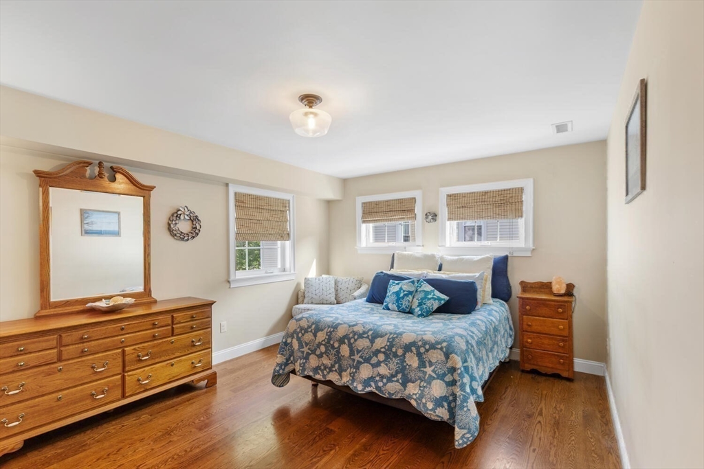 23 Locust Street, Unit 2 Danvers, MA 01923 - Photo 17 of 32 a bedroom with a bed and wooden floor