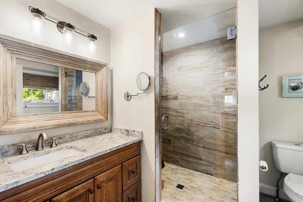 23 Locust Street, Unit 2 Danvers, MA 01923 - Photo 20 of 32 a bathroom with a granite countertop sink toilet and shower