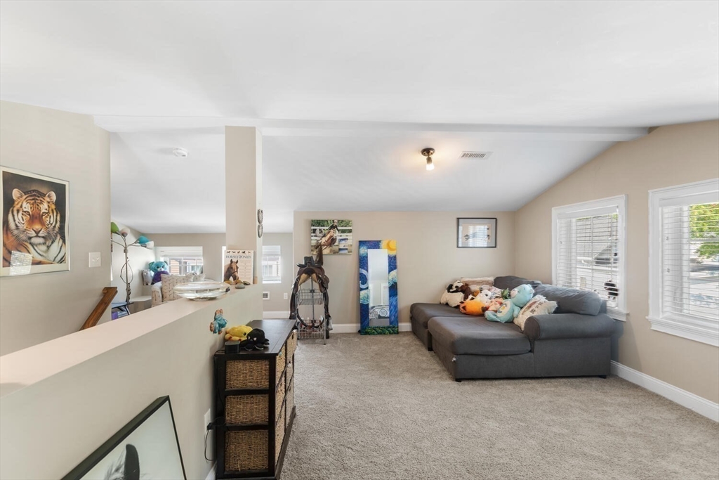 23 Locust Street, Unit 2 Danvers, MA 01923 - Photo 24 of 32 a living room with furniture and a flat screen tv