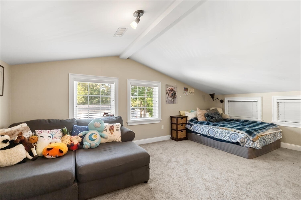 23 Locust Street, Unit 2 Danvers, MA 01923 - Photo 26 of 32 a bedroom with bed couch and window