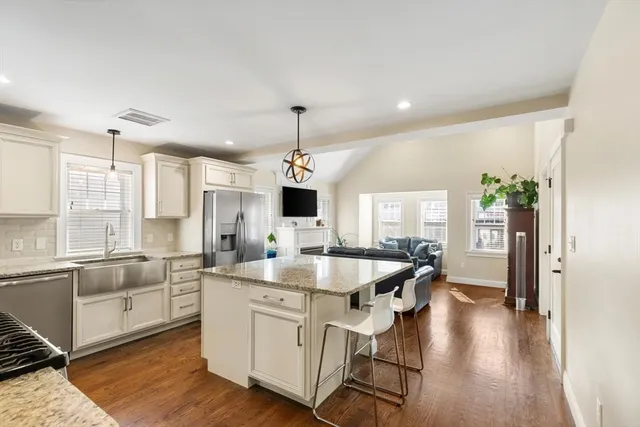 a kitchen with center island and stainless steel appliances