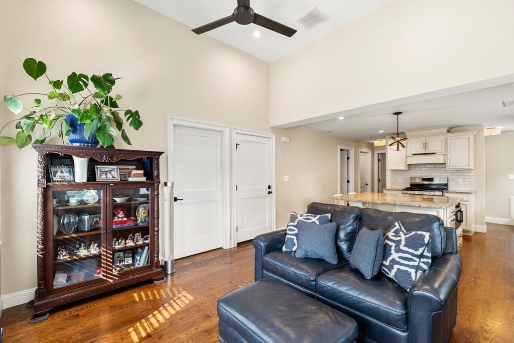 23 Locust Street, Unit 2 Danvers, MA 01923 - Photo 9 of 32 a living room with fireplace furniture and a book shelf
