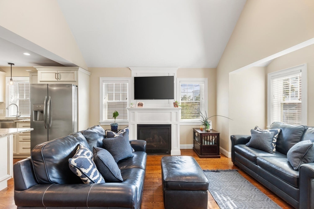 23 Locust Street, Unit 2 Danvers, MA 01923 - Photo 10 of 32 a living room with furniture a fireplace and a flat screen tv