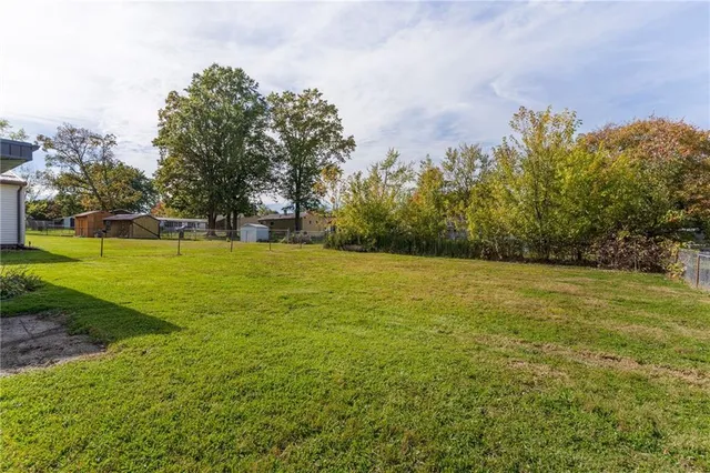a view of a field with an trees