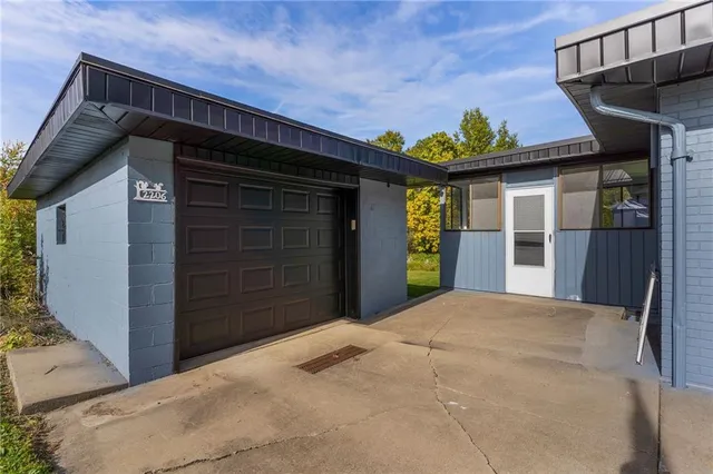 a view of a house with a large window and garage