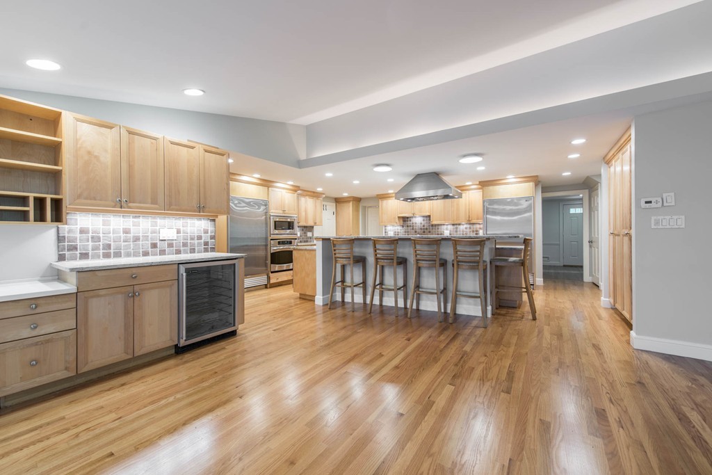 32 Bay State Road Weston, MA 02493 - Photo 1 of 30 a kitchen with a wooden floor kitchen island and stainless steel appliances