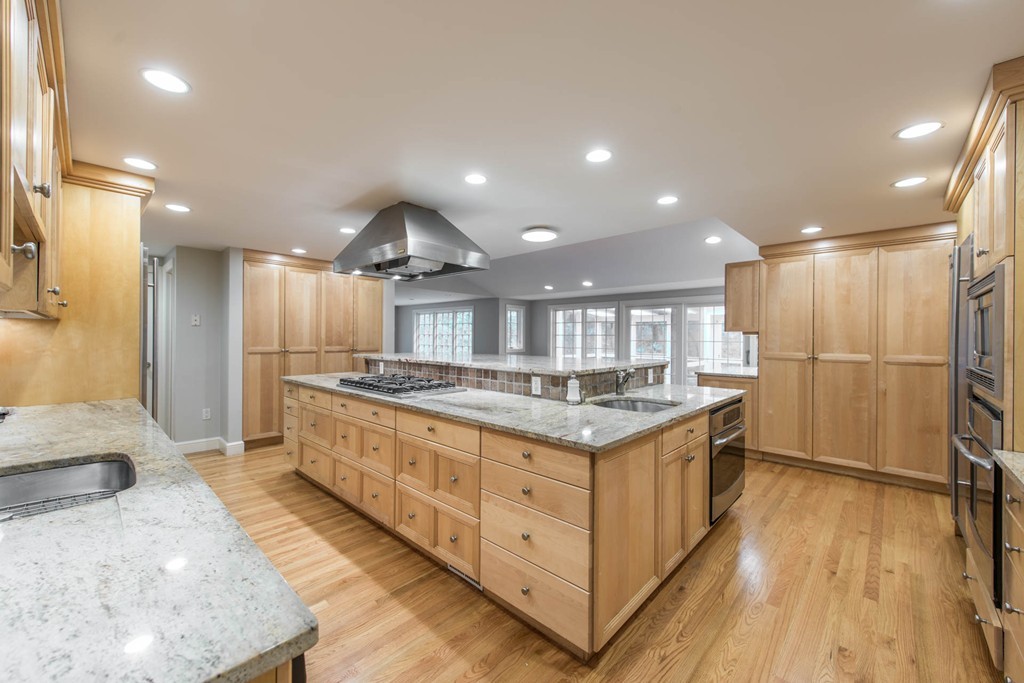32 Bay State Road Weston, MA 02493 - Photo 16 of 30 a kitchen with stainless steel appliances granite countertop a sink stove and refrigerator