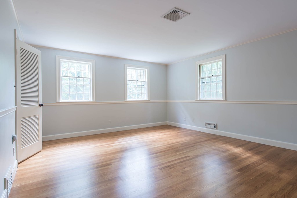 32 Bay State Road Weston, MA 02493 - Photo 20 of 30 an empty room with wooden floor and windows