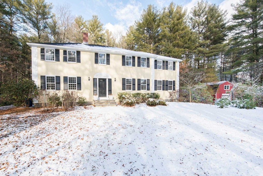 32 Bay State Road Weston, MA 02493 - Photo 2 of 30 a front view of a house with a yard covered with snow and trees