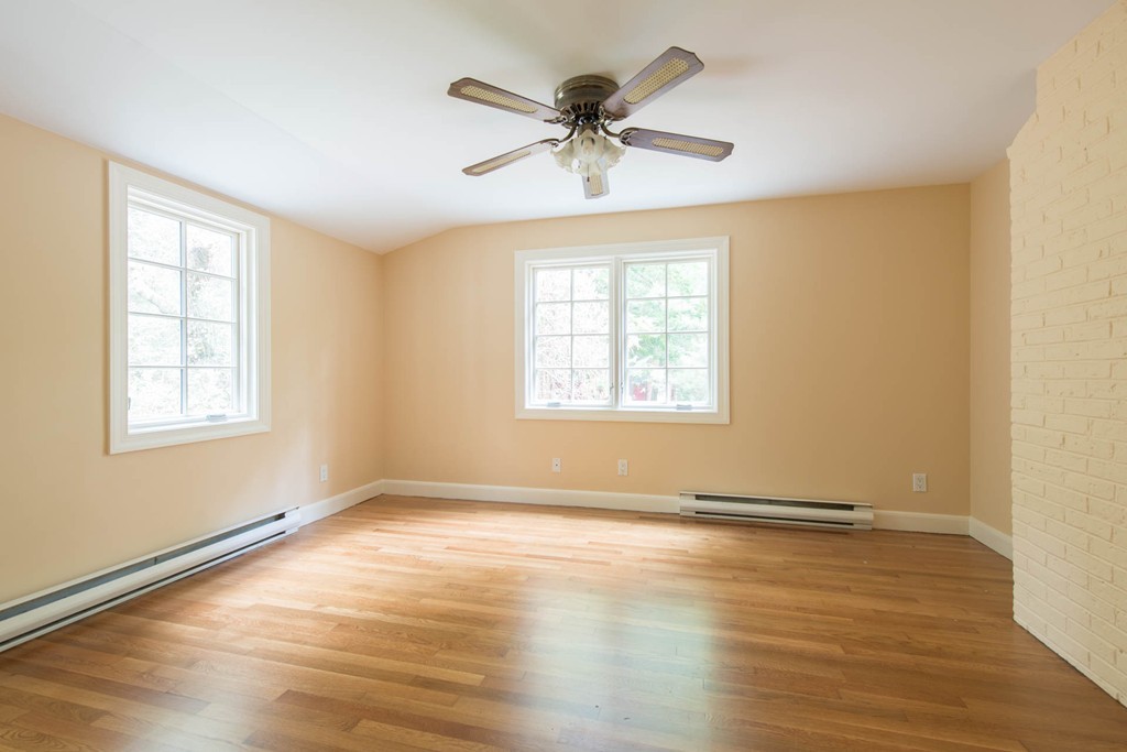 32 Bay State Road Weston, MA 02493 - Photo 27 of 30 a view of an empty room with wooden floor and a window