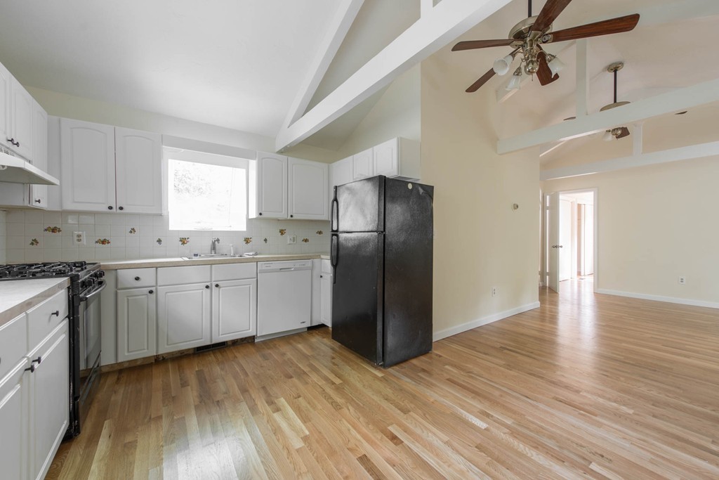 32 Bay State Road Weston, MA 02493 - Photo 3 of 30 a kitchen with stainless steel appliances granite countertop a refrigerator a sink dishwasher and white cabinets with wooden floor