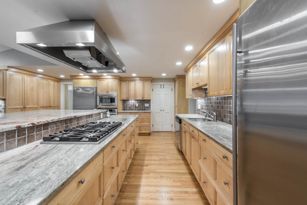 32 Bay State Road Weston, MA 02493 - Photo 6 of 30 a kitchen with stainless steel appliances granite countertop lots of counter top space and wooden floor