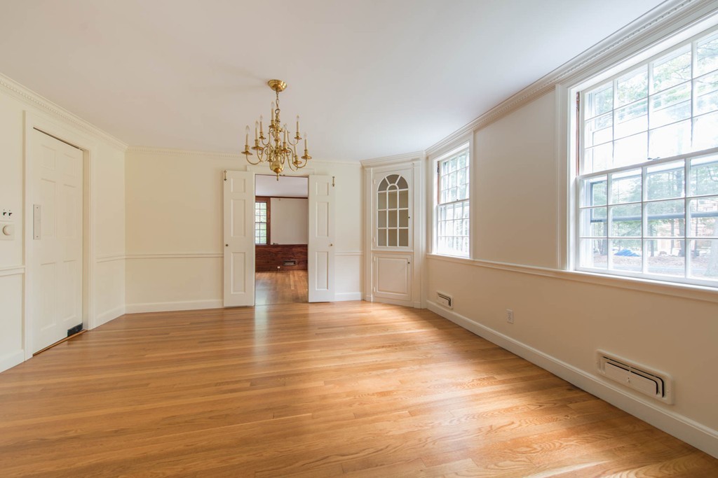 32 Bay State Road Weston, MA 02493 - Photo 10 of 30 a view of an empty room with window and wooden floor