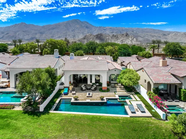 a view of a house with pool and a yard