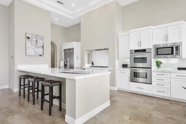 a kitchen with stainless steel appliances a stove sink and microwave