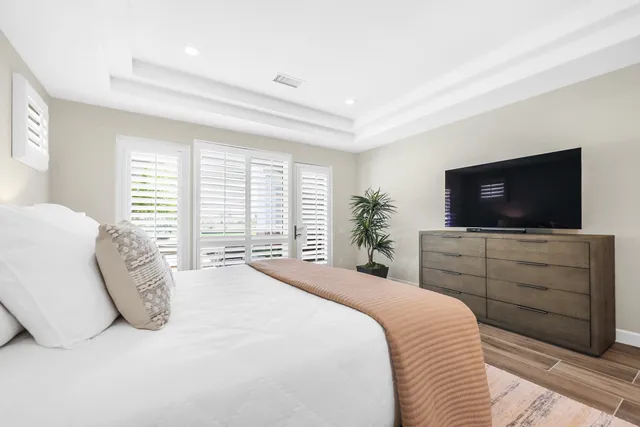 a bedroom with a bed and a flat screen tv