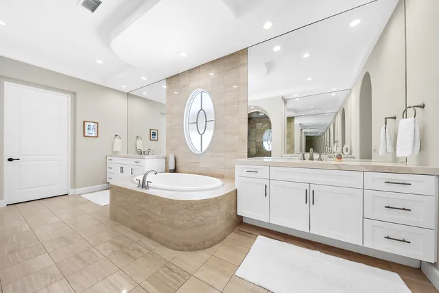 a spacious bathroom with a mirror a sink and a mirror