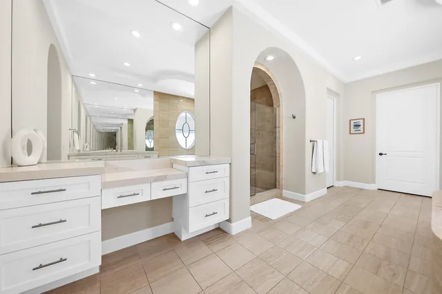 a spacious bathroom with a granite countertop sink mirror and