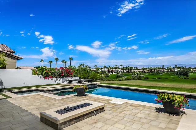a view of a swimming pool and lounge chairs