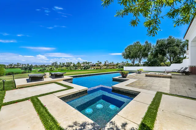 a view of a swimming pool and lounge chair