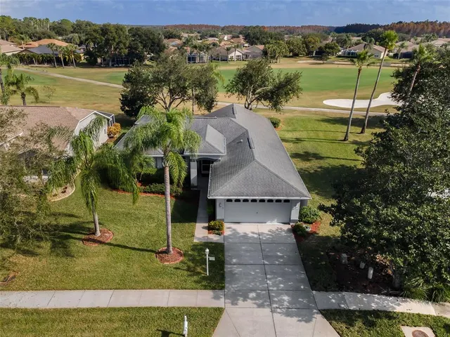 an aerial view of a house with a yard lake view and mountain view
