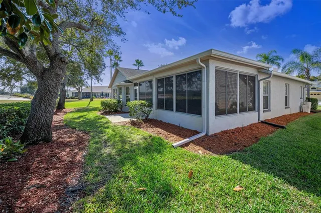 a view of a garden with a building in the background