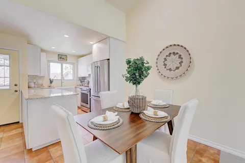 a kitchen with kitchen island granite countertop a sink appliances cabinets and a counter top space
