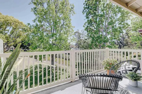 a view of a balcony with wooden floor