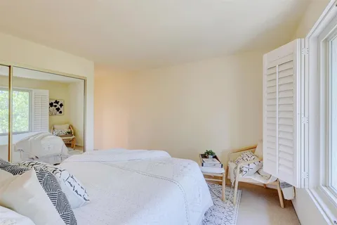 a bedroom with a bed and a couch