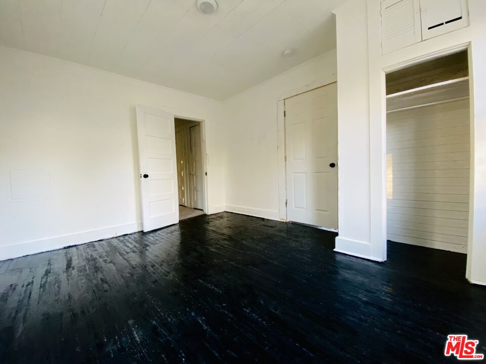 107 Martin Street Mobile, AL 36607 - Photo 5 of 6 a view of empty room with wooden floor and fan