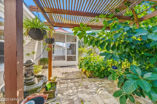 a view of a porch with a table and chairs and potted plants