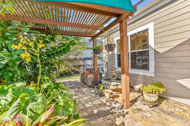 a house with a big yard and potted plants