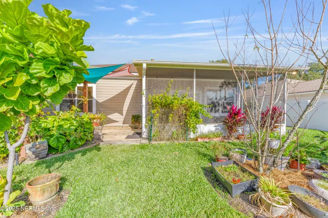 a view of a house with yard and a garden