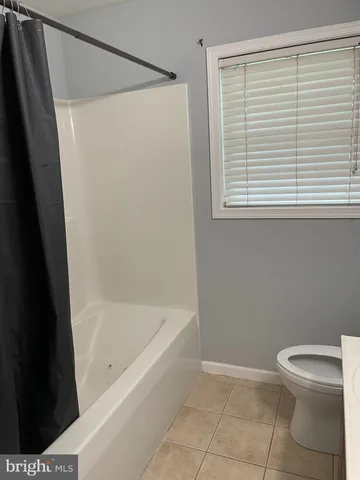 a white bath tub sitting next to a white toilet