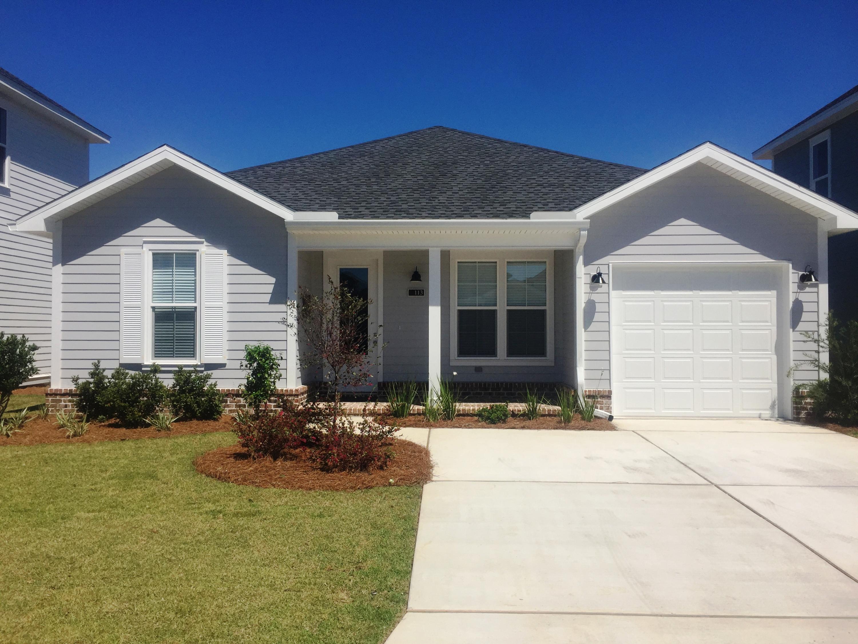 167 North Zander Way Santa Rosa Beach, FL 32459 - Photo 1 of 30 a front view of a house with a yard and glass windows and yard