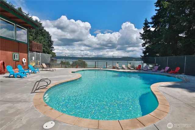 a view of a swimming pool with an outdoor seating