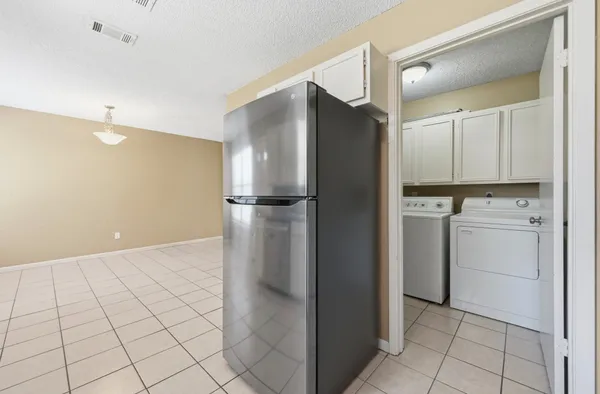 a kitchen with white cabinets and white appliances