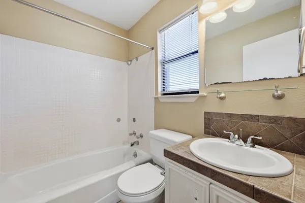 a bathroom with a sink toilet a mirror and shower