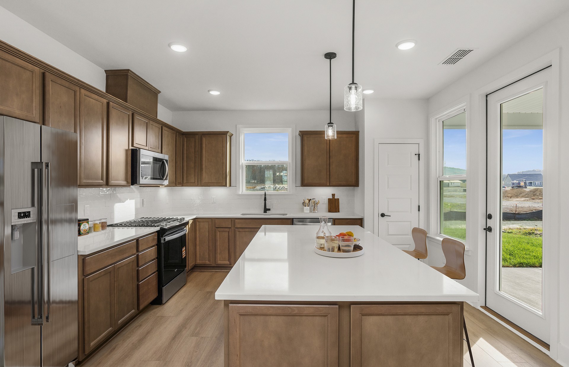 519 Scarlet Oak Road Lebanon, TN 37090 - Photo 14 of 51 a kitchen with stainless steel appliances granite countertop a sink a stove and a refrigerator